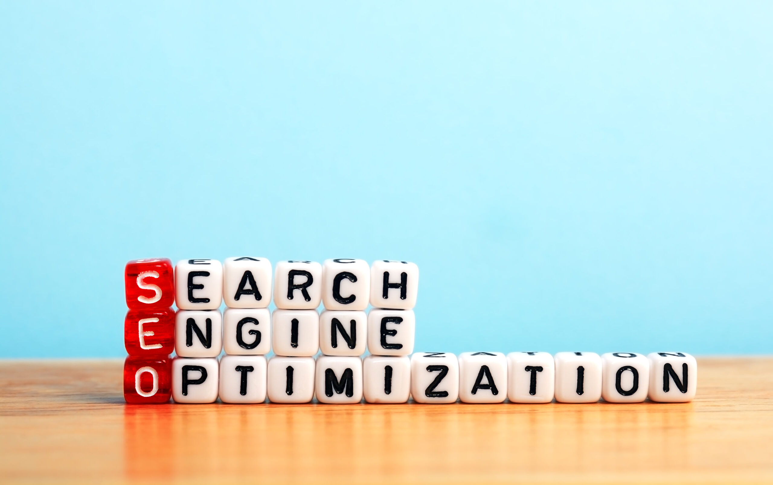 seo search engine optimization written on dices on blue background